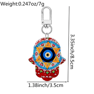 Detail view of Hamsa Hand keychain with Evil Eye print and dimensions of 8.5cm by 3.5cm