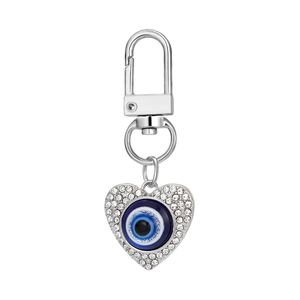 Detailed view of a silver heart-shaped evil eye keychain with sparkling rhinestones