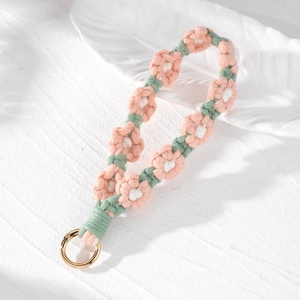 Handmade woven daisy flower keychain with pink petals and golden metal spring clasp