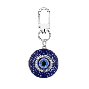 Close-up of evil eye keychain with blue enamel and sparkling white crystals decoration