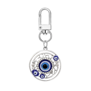 Detail of evil eye keychain with blue crystals and sparkling white rhinestones on silver base