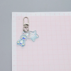 Translucent bunny keychain with iridescent star charm and silver metal swivel clasp hook