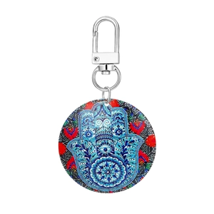 Detailed close-up of a Hamsa Hand keychain pendant with intricate geometric folk patterns