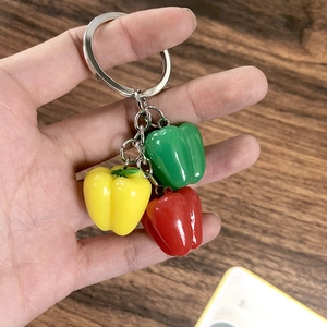 Detailed view of colorful red yellow and green resin chili pepper keychain pendant