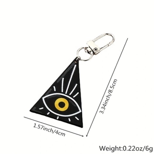 Detail view of black acrylic Evil Eye keychain with size dimensions and silver clasp