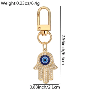 Detail view of Hamsa Hand keychain with blue evil eye charm and white rhinestones