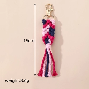 Detail view of woven cotton rope keychain with pink tassels and gold lobster clasp