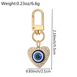 Detail view of heart evil eye keychain with rhinestone inlay and size specifications