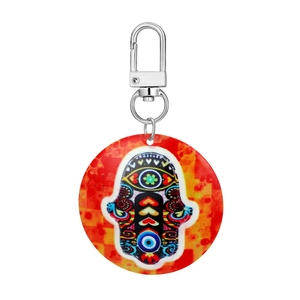 Detail of Hamsa Hand acrylic keychain with colorful tribal patterns and silver metal clasp