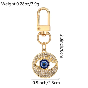 Detailed view of evil eye keychain dimensions showing 6cm length and golden rhinestone finish