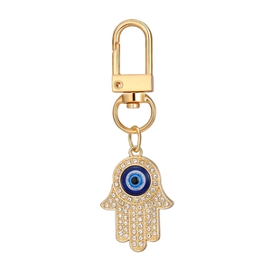 Detailed view of Hamsa Hand keychain with crystal pavé and blue evil eye charm