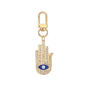 Golden Hamsa hand keychain set with evil eye charm and sparkling white crystal stones