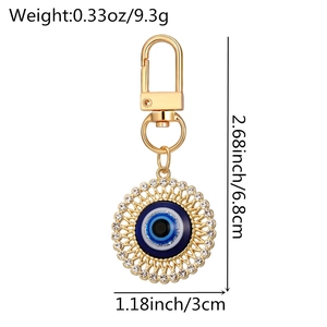 Detailed view of evil eye keychain with gold plating and dimensions 2.68x1.18 inches