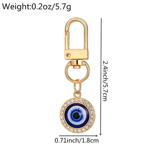 Detailed size and weight view of a golden Evil Eye keychain with dimensions and oz/g specs