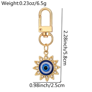 Golden sun evil eye keychain detail with rhinestone inlay and specific dimensions