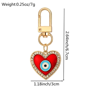 Detail of red evil eye heart keychain with rhinestones showing dimensions and weight