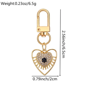 Detailed macro view of heart keychain with blue flower crystals and size dimensions