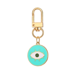 Evil Eye keychain with mint green enamel, gold plating, and eyelash detail charm