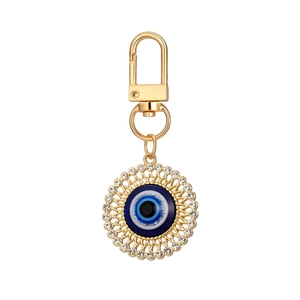 Golden Evil Eye keychain with blue solar cutout design and sparkling rhinestones