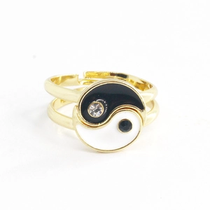 Macro detail of gold adjustable yin yang ring with black and white enamel and rhinestones