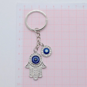 Turkish Evil Eye and Hamsa Hand keychain with blue rhinestones on a silver metal alloy base