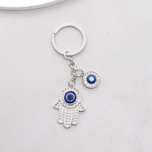 Turkish evil eye Hamsa hand keychain with silver metal alloy and blue crystal pendants
