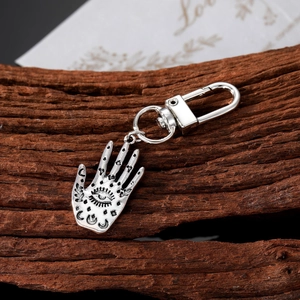 Vintage Hamsa Hand keychain in antique silver alloy with Evil Eye and cosmic symbols