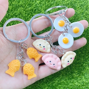 Handheld creative resin mini food keychains featuring cute gyoza and fish-shaped charms