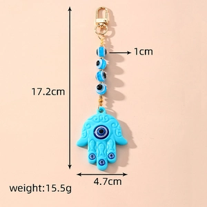 Blue Hamsa Hand and Evil Eye keychain made of acrylic with product dimensions and weight