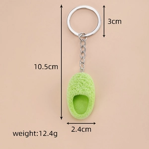 Detail of green flocked resin mini slipper keychain showing plush texture and dimensions