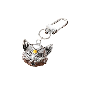 Vintage silver alloy fox keychain with a yellow gemstone accent on minimalist background