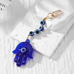 Bohemian evil eye Hamsa hand keychain with blue acrylic beads and golden metal clasp