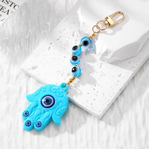 Bohemian Hamsa Hand and Evil Eye keychain with light blue beads and golden metal hardware