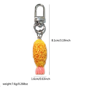 Macro detail of tempura shrimp keychain showing dimensions 8.1cm length and silver ring