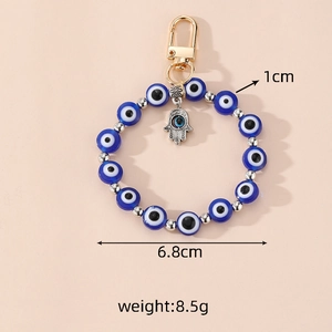 Macro detail of Evil Eye beaded keychain with Hamsa Hand charm showing 6.8cm diameter