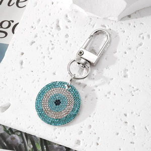 Macro view of blue crystal Evil Eye keychain with polished silver lobster clasp detail
