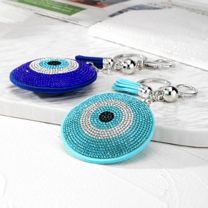 Sparkling Evil Eye keychain with leather tassels and crystals in blue and light blue colors