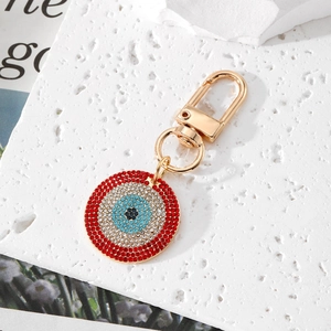 Sparkling Evil Eye keychain with blue and red crystals in golden circular setting