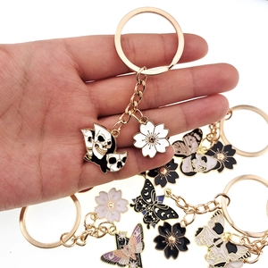 Golden cherry blossom and skull butterfly enamel keychains for bags and purses
