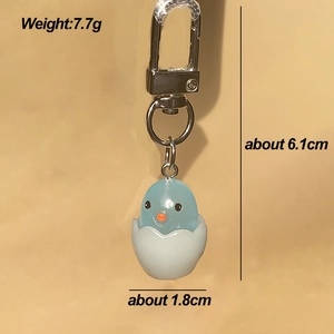 Detailed view of blue chick in eggshell keychain with silver lobster clasp and size dimensions