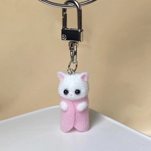 Detail of cute flocked kitten keychain with pink felt body and silver metal spring clasp