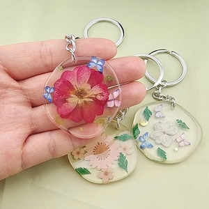 Handgefertigter Schlüsselanhänger aus Kunstharz mit echten getrockneten Rosen und Schmetterlingen