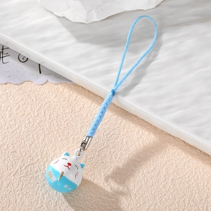 Close-up of a blue and white lucky cat bell pendant with a blue woven lanyard and metal buckle