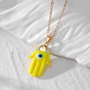 Ethnic Hamsa Hand necklace with yellow resin pendant and blue evil eye detail