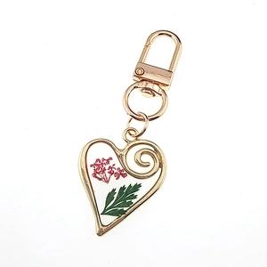 Creative heart shaped keychain with real red dried flowers in clear resin and gold frame