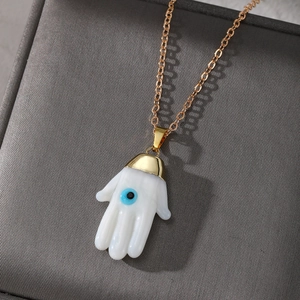 Ethnic Hamsa Hand necklace with blue Evil Eye pendant on gold chain and jewelry box