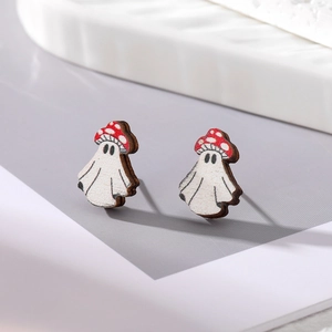 Detailed macro view of ghost earrings with mushroom hats showing wood grain texture