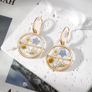 Handmade gold geometric circular earrings with colorful dried flowers in clear resin