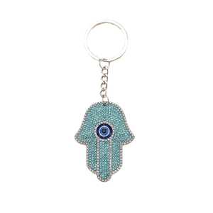 Hamsa hand keychain with blue rhinestones and evil eye charm on silver alloy base