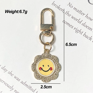 Detail of sunflower keychain with sparkling rhinestones and yellow enamel smile charm